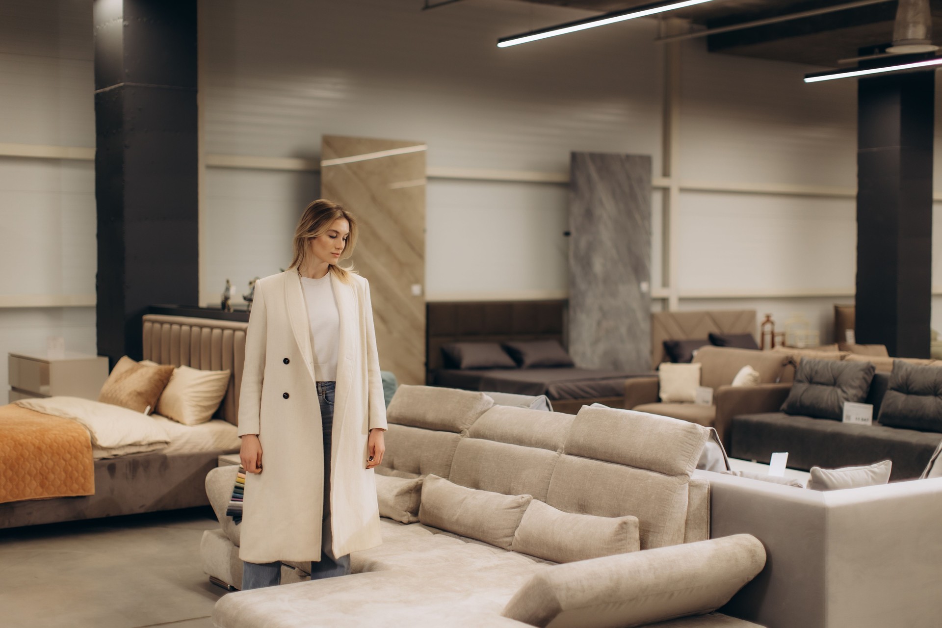 Woman Shopping for Furniture in a Stylish Modern Interior Showroom